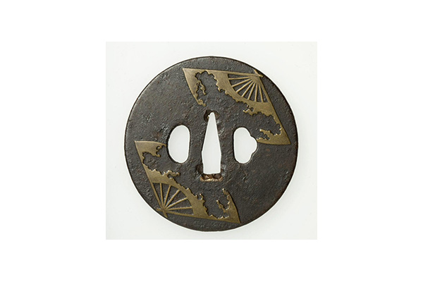 Japanese Arts of Daily Life
Round sword guard (tsuba) with design of two horn fans, 1700-1800. Japan, Edo period (1615-1868). Iron with brass inlay. Transfer from the Fine Arts Museums of San Francisco, B87W13.
