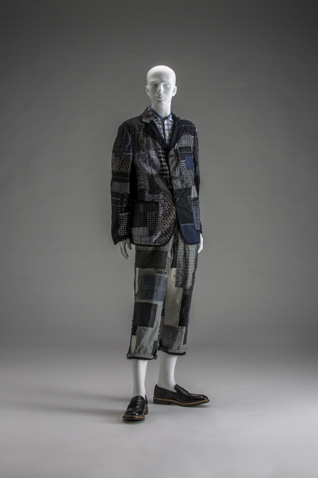 Jacket, shirt, and trousers, Spring/Summer 2015, by Junya Watanabe (Japanese, b. 1961) for Junya Watanabe Comme des Garçons Man. Jacket: Multiple fabric types (approximately fifteen) including cotton, wool, linen, rayon, and polyester; shirt: cotton plain weave; trousers: multiple types of cotton and linen (approximately fifteen). Collection of The Kyoto Costume Institute. © The Kyoto Costume Institute, photo by Takashi Hatakeyama.

